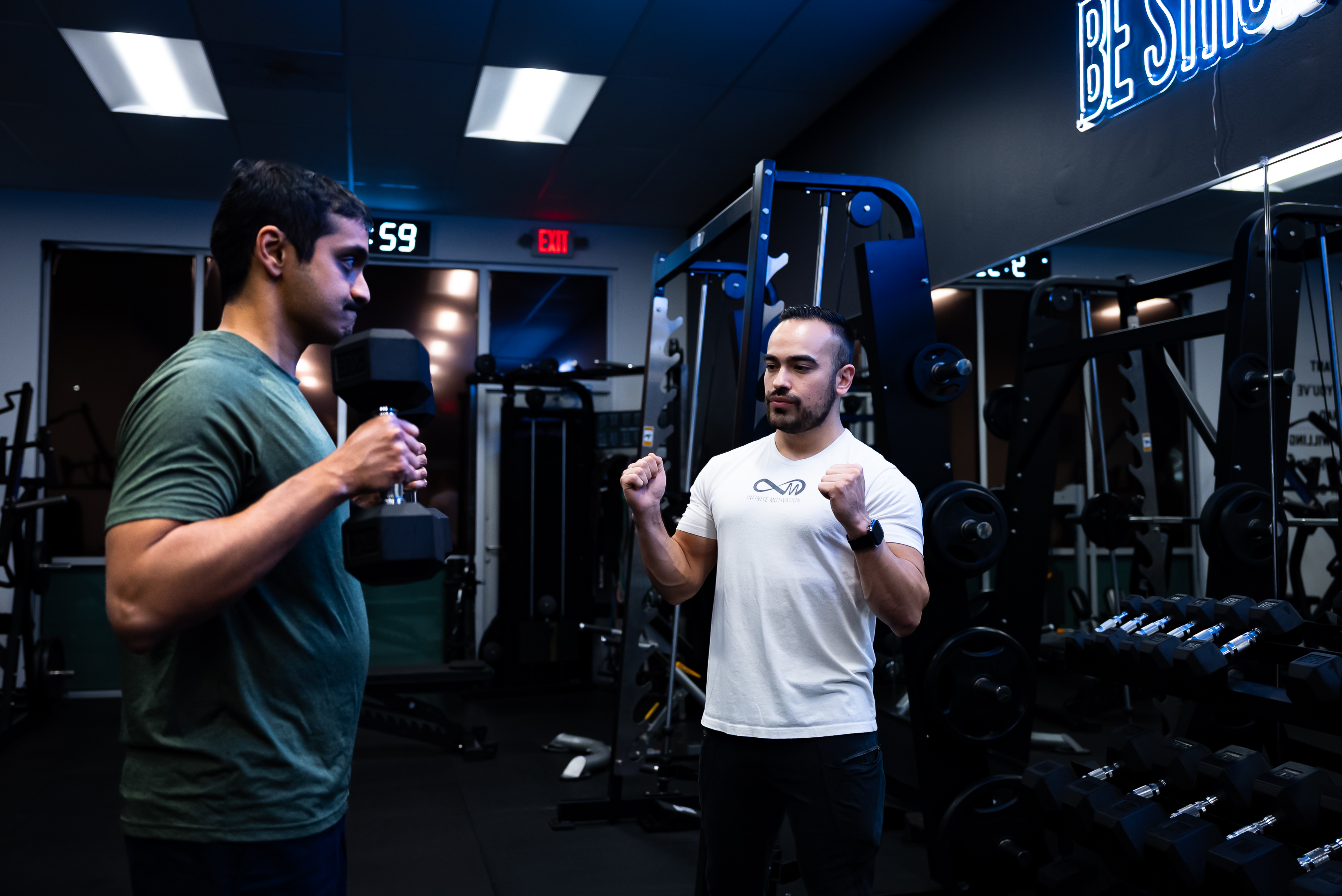 Client working with trainer on strength exercises