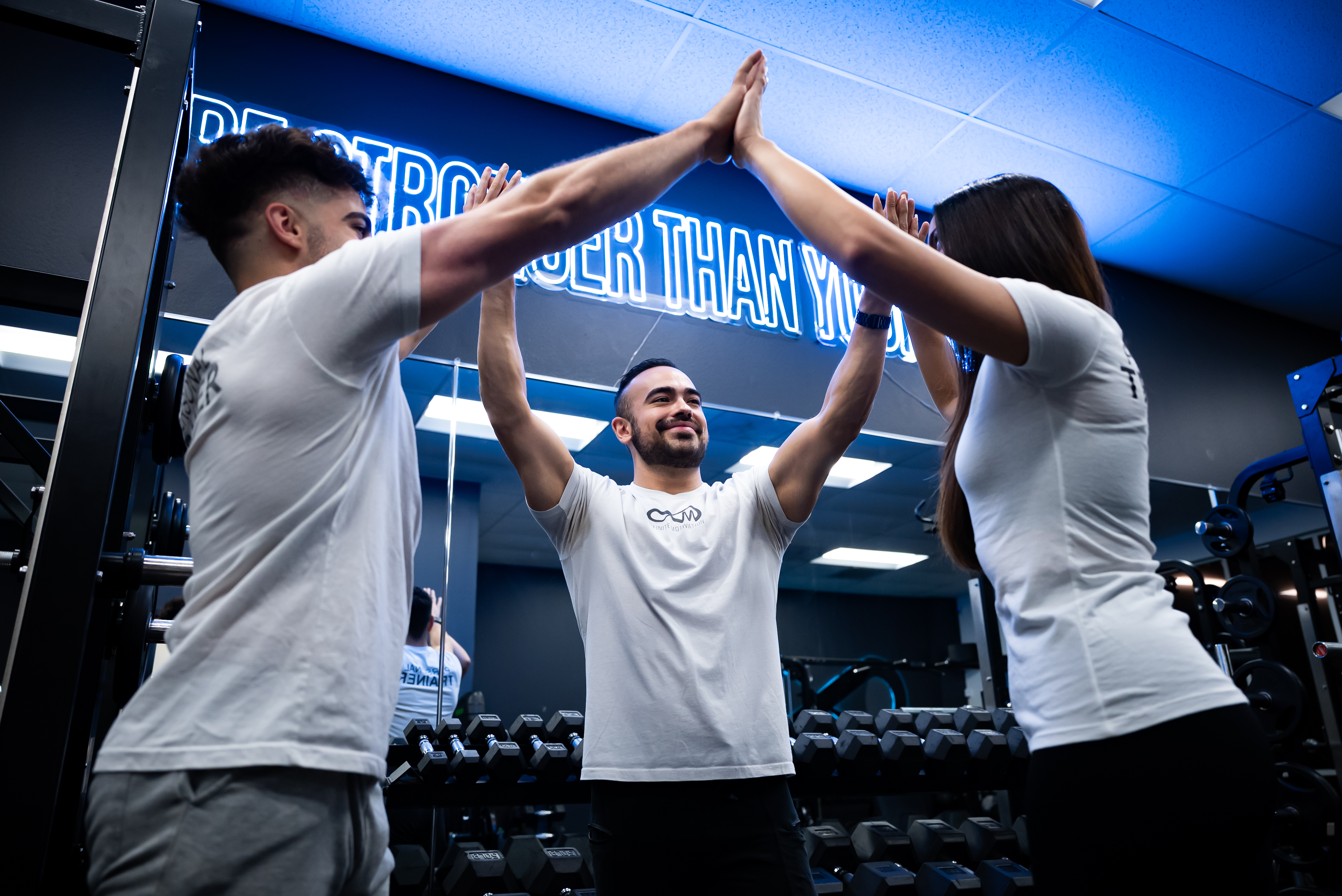 Team celebrating with hands raised to ceiling in studio